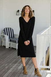 Model Emma wearing size S of The Transeasonal Knit Dress in colour Black (Black), from the front, showing the whole outfit