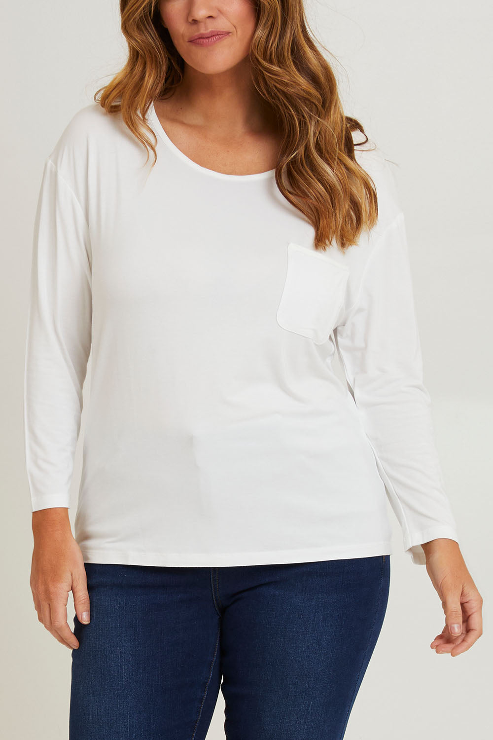Model Laura wearing size 14 of The Relaxed Satin Bind Tee in colour White (White), from the front, cropped image