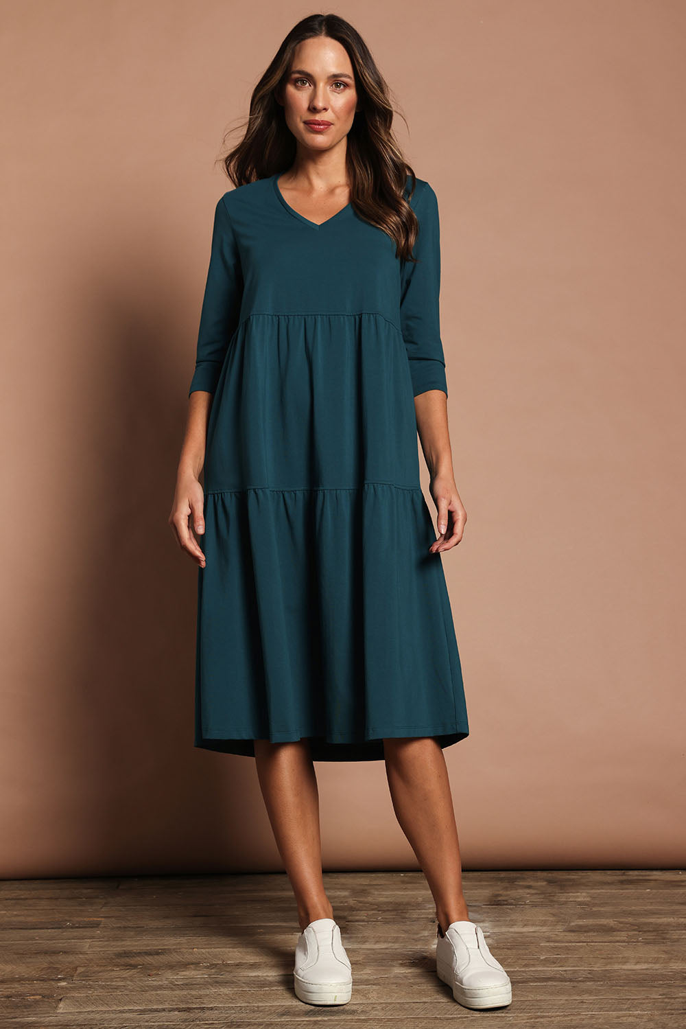 Model Madeline wearing size 10 of The 3/4 Sleeve Tiered Jersey Dress in colour Deepgreen (Green), from the front, showing the whole outfit