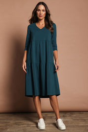 Model Madeline wearing size 10 of The 3/4 Sleeve Tiered Jersey Dress in colour Deepgreen (Green), from the front, showing the whole outfit