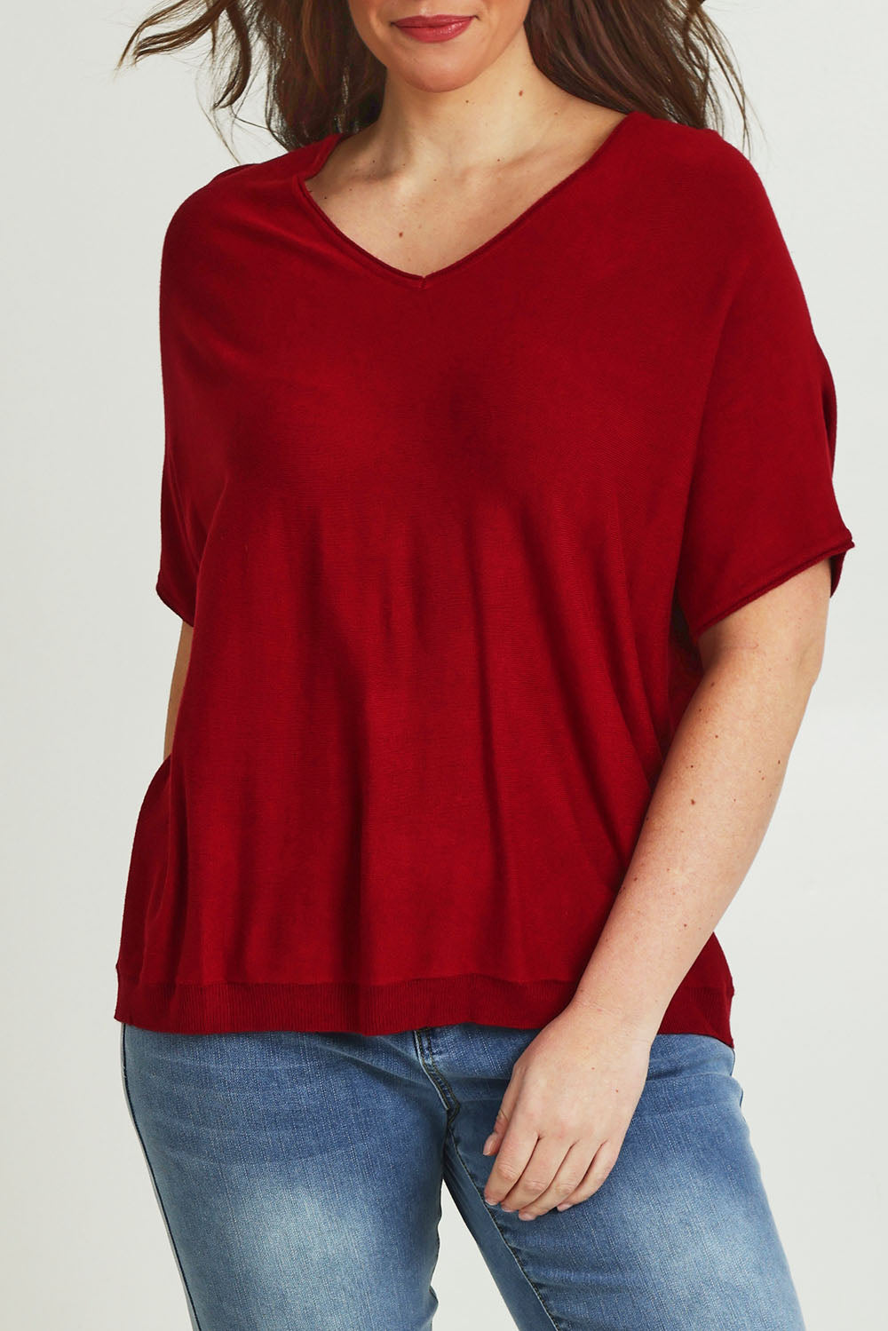 Model Jane wearing size L of The Relaxed V Neck Knit Tee in colour Raspberry (Red), from the front, cropped image