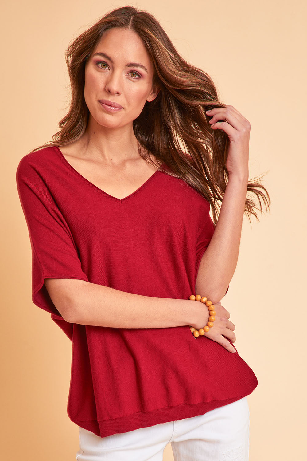 Model Madeline wearing size S of The Relaxed V Neck Knit Tee in colour Raspberry (Red), from the front, showing the whole outfit