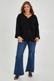 Model Monique wearing size 14 of The Fluted Sleeve Top in colour Black (Black), from the front, showing the whole outfit
