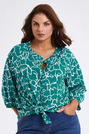 Model Monique wearing size 14 of The Keepers Crew Neck Printed Shirt in colour Tealwhite (Green), from the front, cropped image