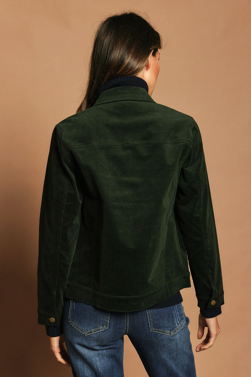 Model Madeline wearing size 10 of The Keepers Cord Jacket in colour Deepforest (Green), from the back