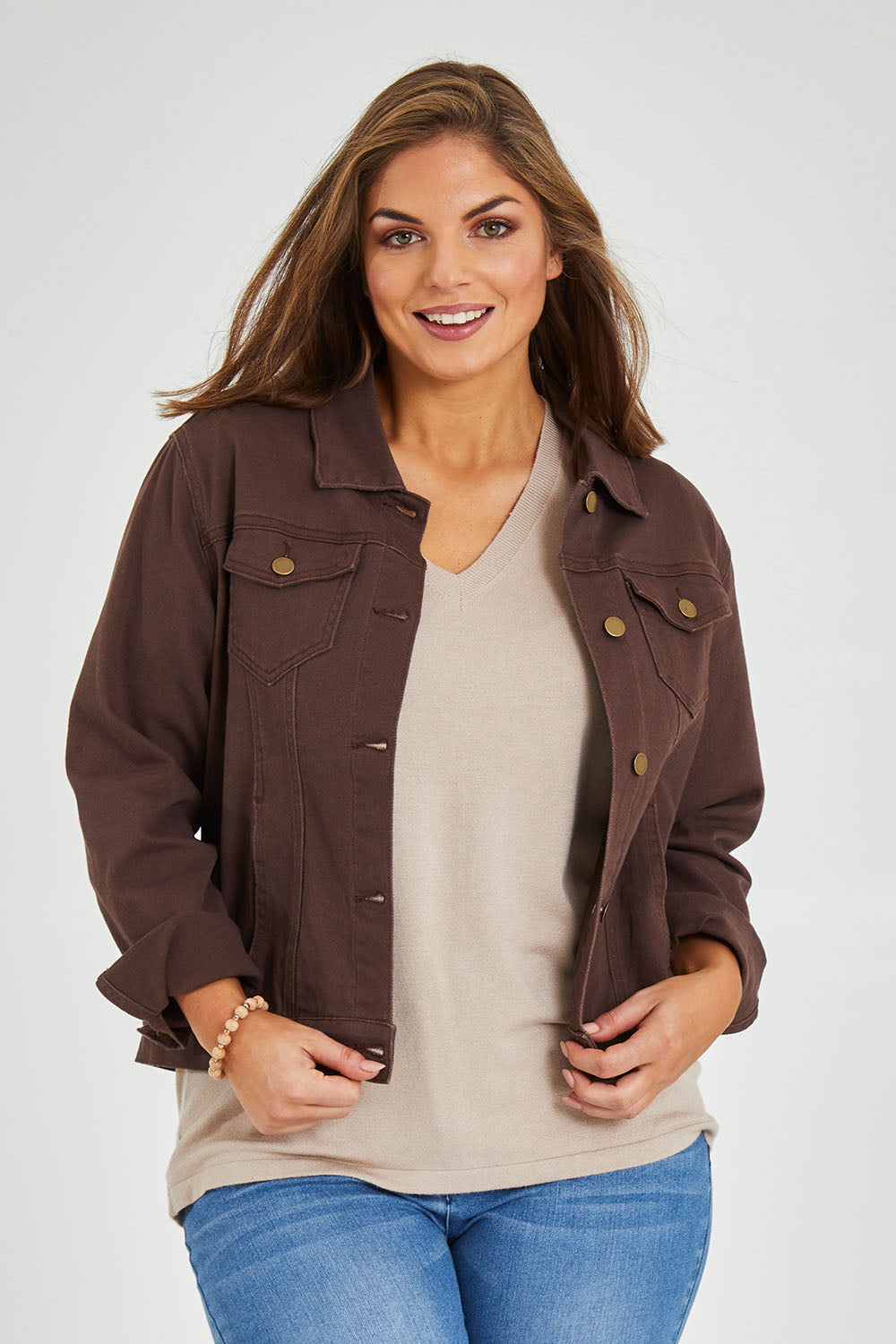 Model Monique wearing size 14 of The Slim Fit Denim Jacket in colour Chocolate, from the front, cropped image