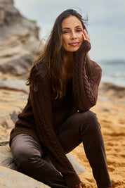Model Amanda wearing size S of The V Neck Cable Knit Jumper in colour Coffeebean, from the front, showing the whole outfit