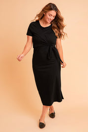 Model Laura wearing size 14 of The Short Sleeve Side Tie Tee Dress in colour Black (Black), from the front, showing the whole outfit