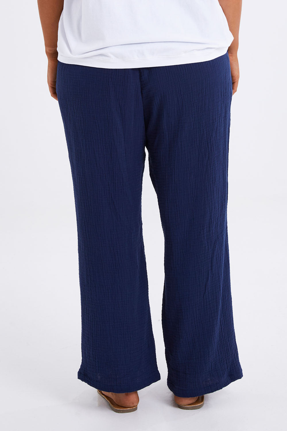 Model Monique wearing size 14 of The Double Cotton Pull On Pant in colour Navy (Blue), from the back
