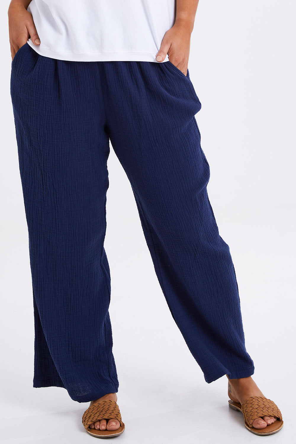 Model Monique wearing size 14 of The Double Cotton Pull On Pant in colour Navy (Blue), from the front, cropped image