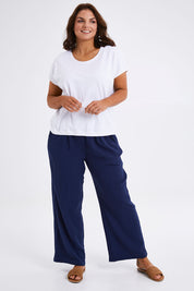 Model Monique wearing size 14 of The Double Cotton Pull On Pant in colour Navy (Blue), from the front, showing the whole outfit