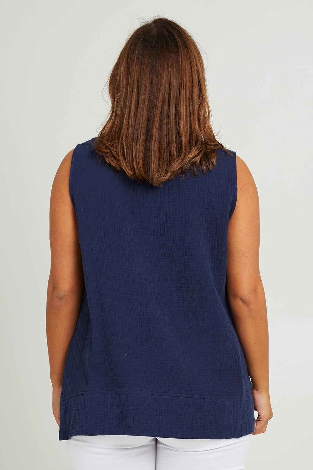 Model Monique wearing size 14 of The Double Cotton V Tank in colour Navy (Blue), from the back