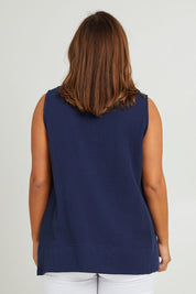 Model Monique wearing size 14 of The Double Cotton V Tank in colour Navy (Blue), from the back