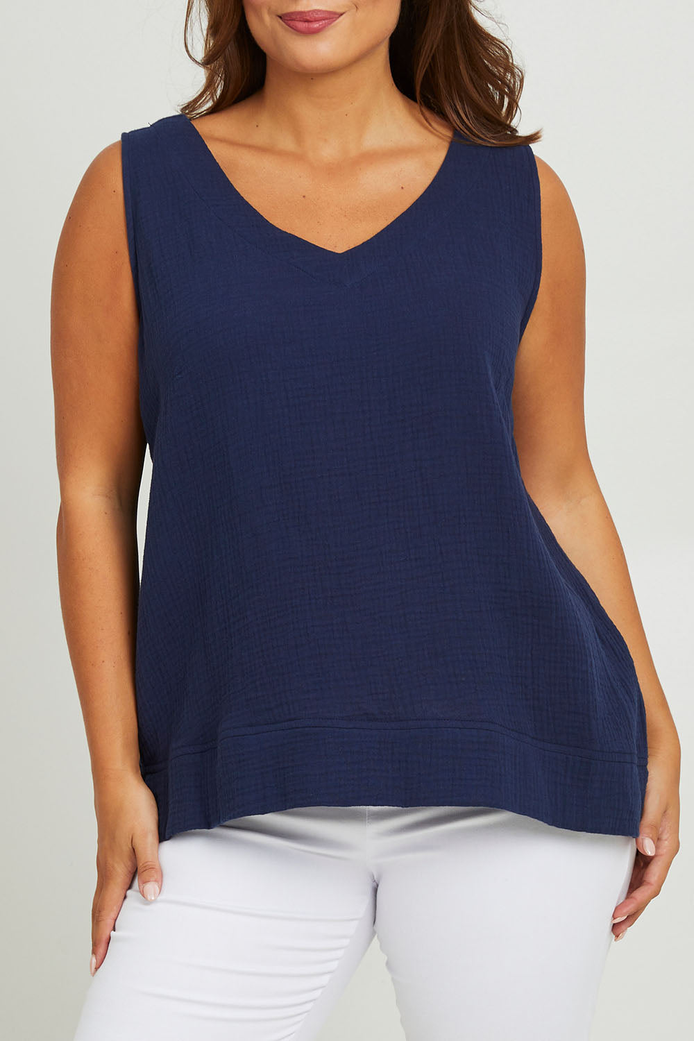Model Monique wearing size 14 of The Double Cotton V Tank in colour Navy (Blue), from the front, cropped image