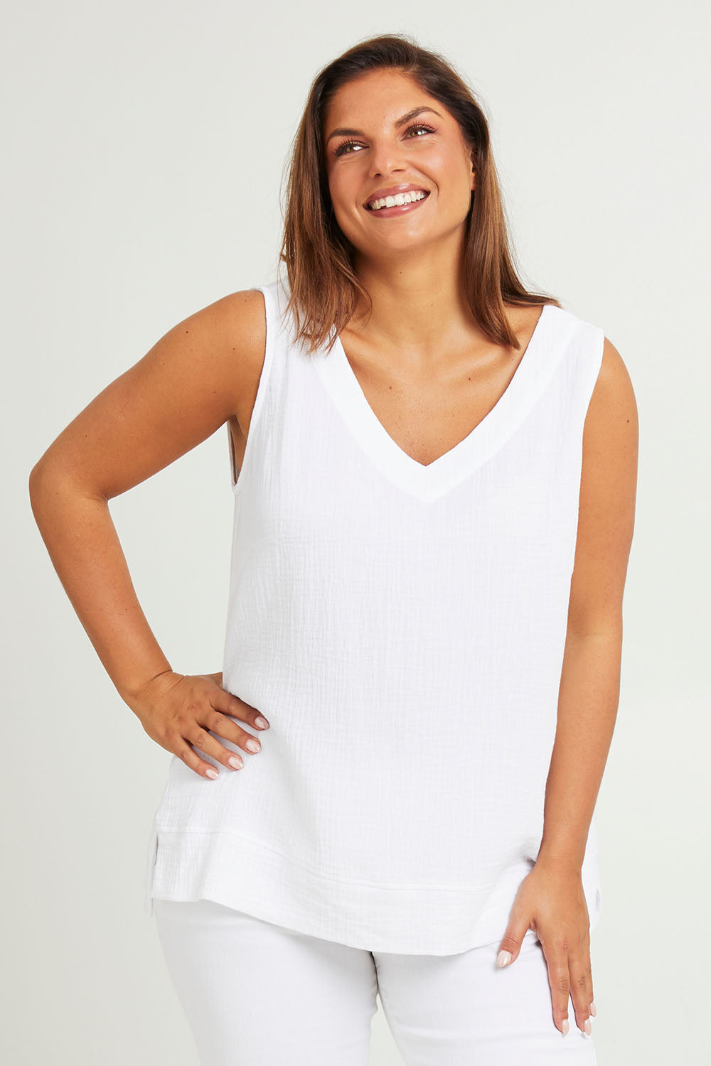 Model Monique wearing size 14 of The Double Cotton V Tank in colour White (White), from the front, cropped image
