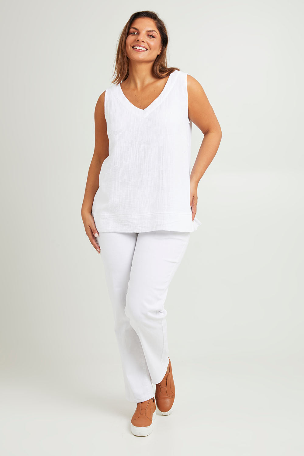 Model Monique wearing size 14 of The Double Cotton V Tank in colour White (White), from the front, showing the whole outfit