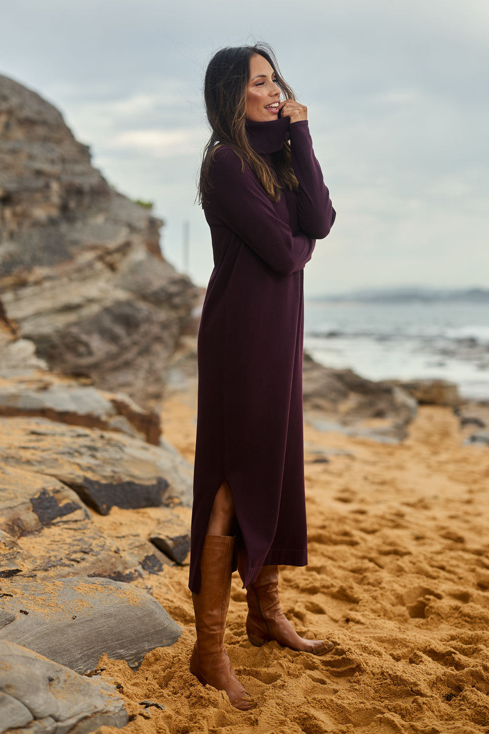 Model Amanda wearing size S of The Roll Neck Knit Maxi Dress in colour Burntplum (Purple), from the front, showing the whole outfit