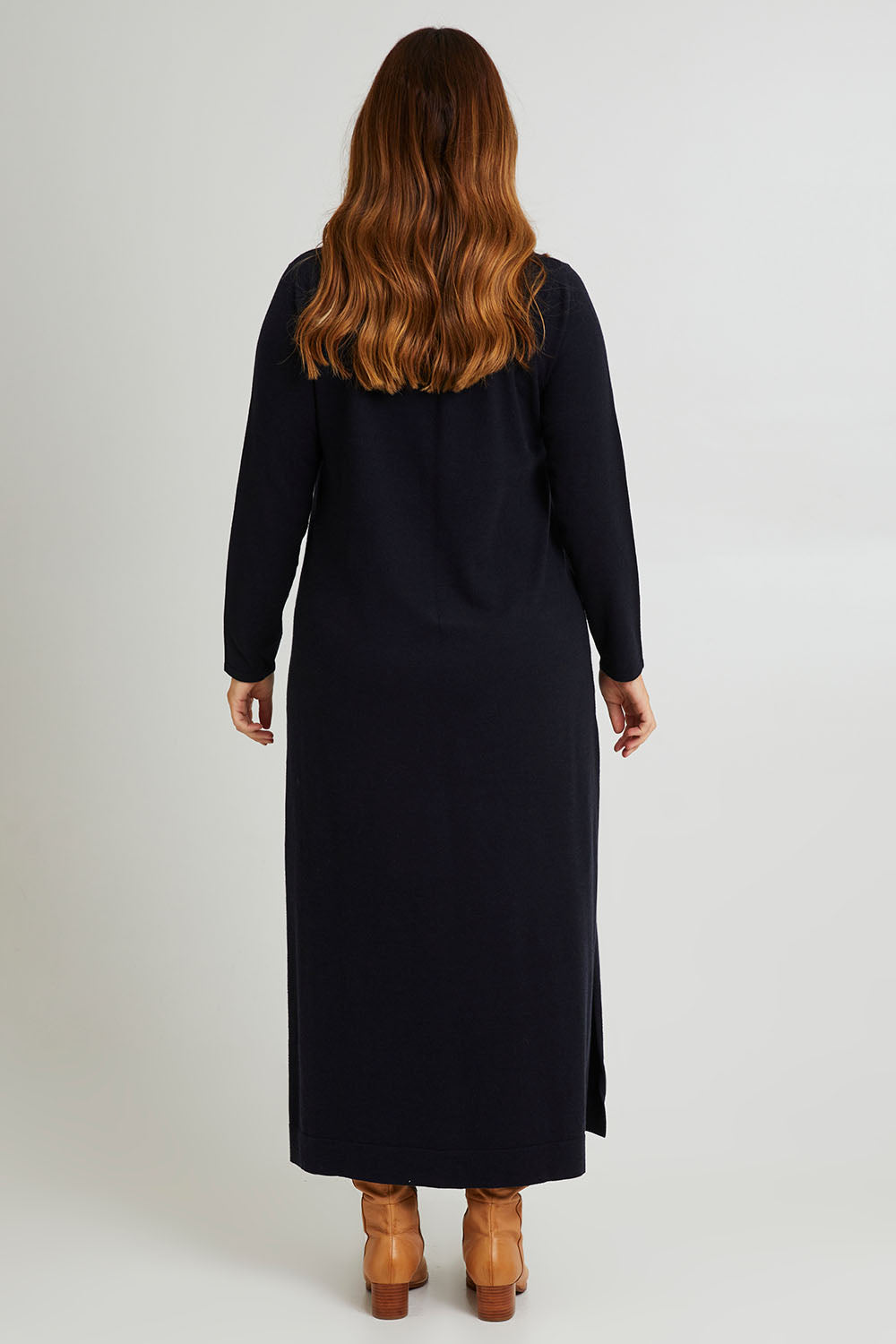 Model Laura wearing size L of The Roll Neck Knit Maxi Dress in colour Darknavy (Blue), from the back