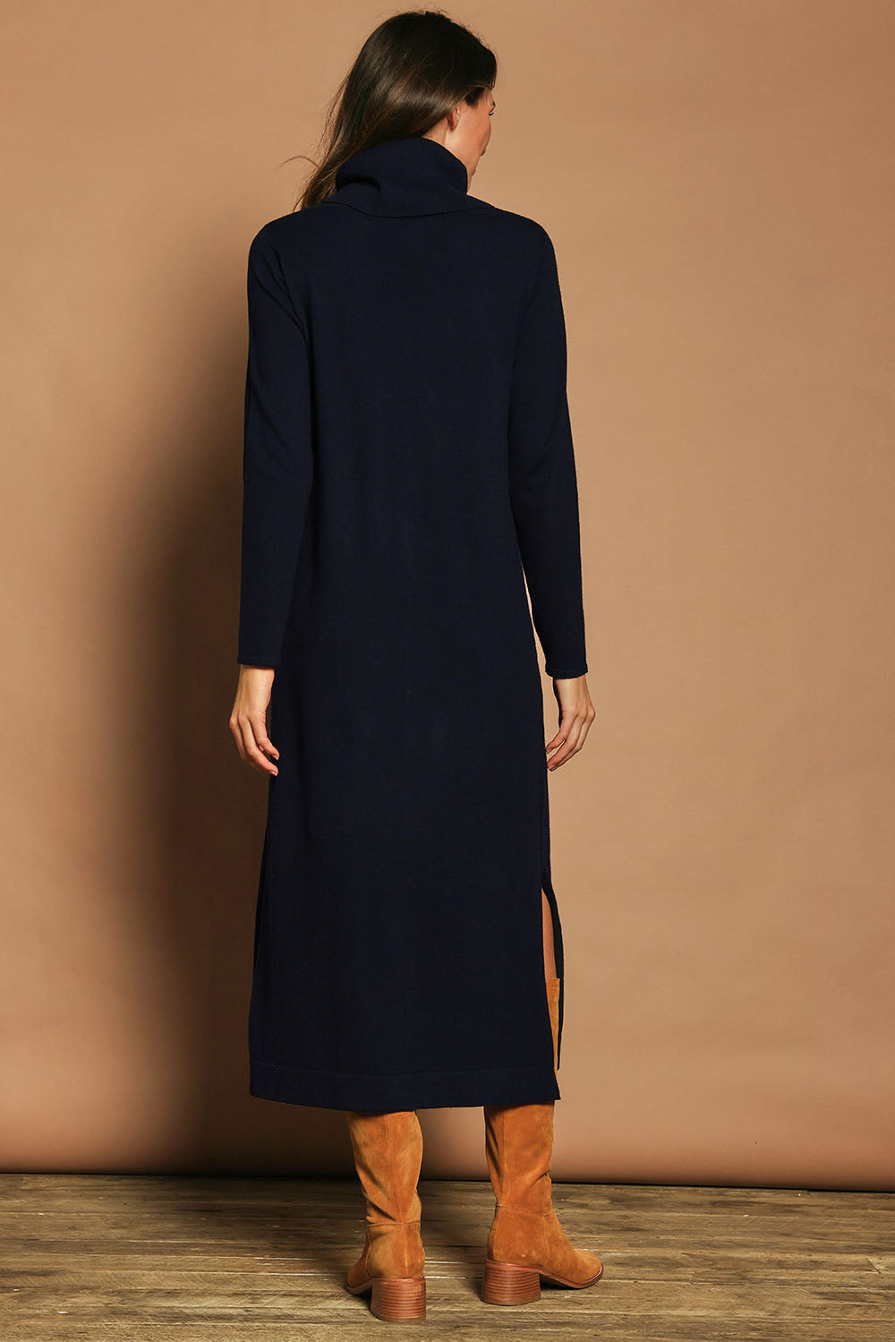 Model Madeline wearing size S of The Roll Neck Knit Maxi Dress in colour Darknavy (Blue), from the back