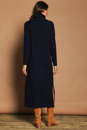 Model Madeline wearing size S of The Roll Neck Knit Maxi Dress in colour Darknavy (Blue), from the back