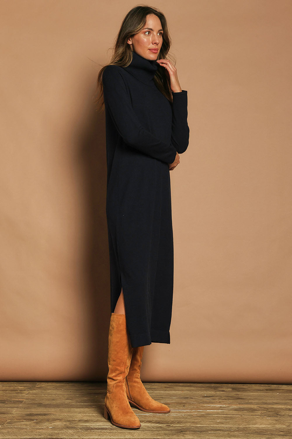 Model Madeline wearing size S of The Roll Neck Knit Maxi Dress in colour Darknavy (Blue), from the front, showing the whole outfit