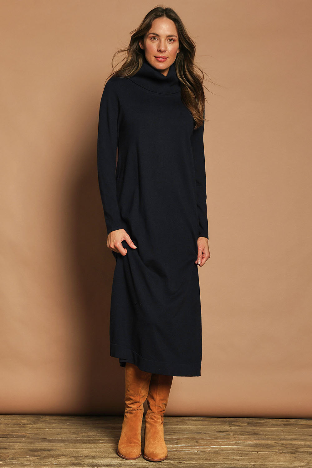 Model Madeline wearing size S of The Roll Neck Knit Maxi Dress in colour Darknavy (Blue), from the front, showing the whole outfit