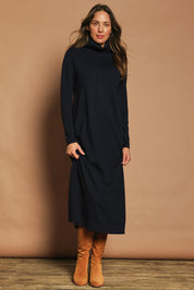 Model Madeline wearing size S of The Roll Neck Knit Maxi Dress in colour Darknavy (Blue), from the front, showing the whole outfit