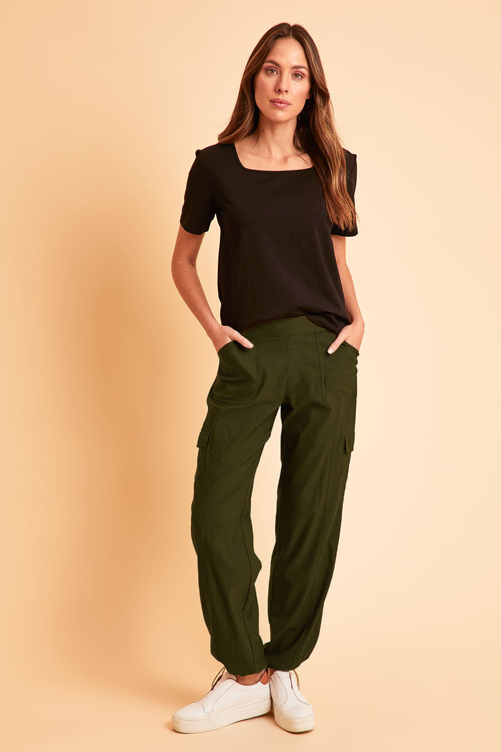 Model Madeline wearing size 10 of The Everyday Full Length Cargo Pant in colour Olive (Green), from the front, showing the whole outfit