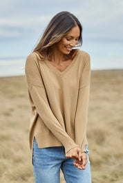Model Amanda wearing size S of The High Low V Neck Jumper in colour Fawn, from the front, showing the whole outfit