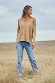 Model Amanda wearing size S of The High Low V Neck Jumper in colour Fawn, from the front, showing the whole outfit