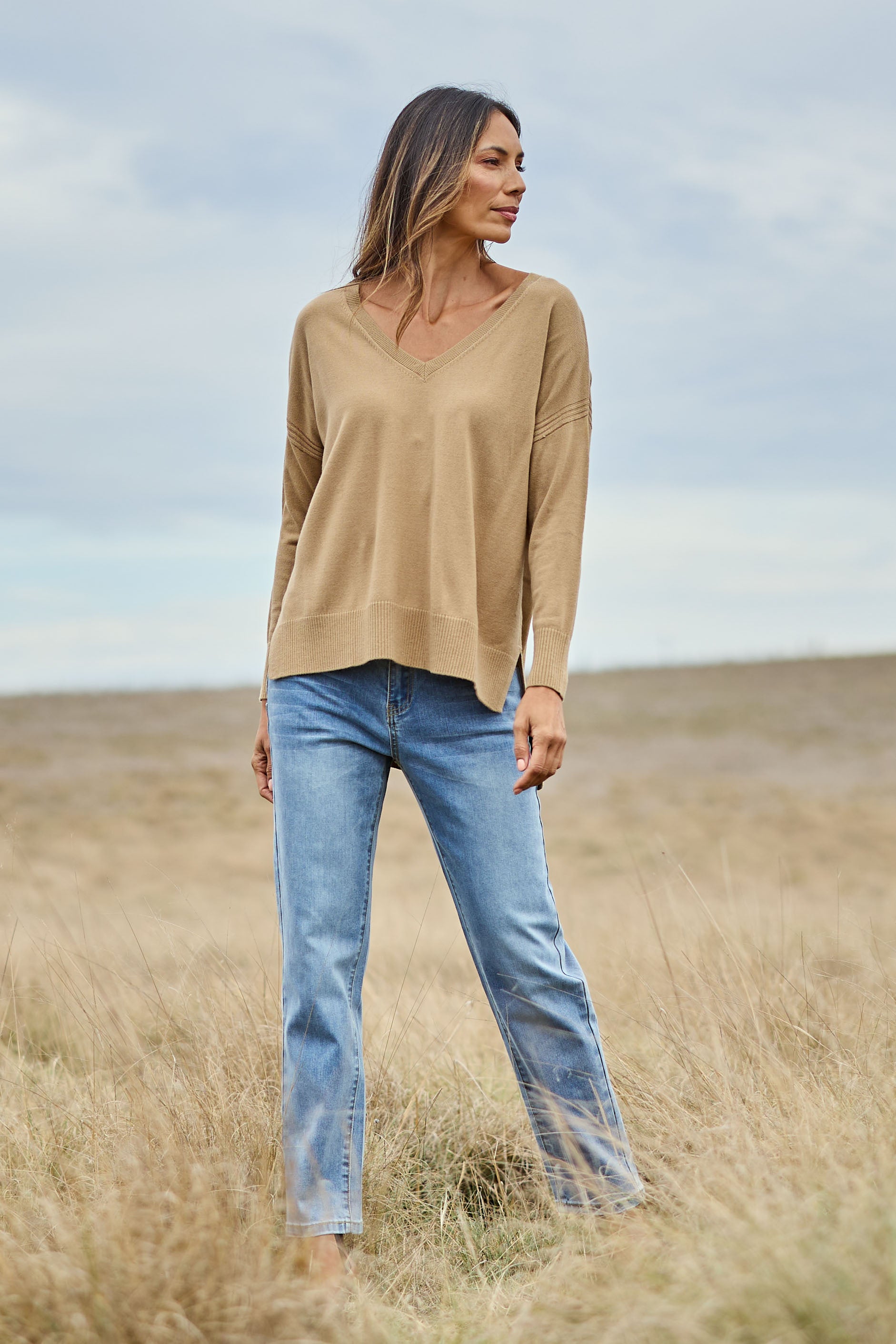 Model Amanda wearing size S of The High Low V Neck Jumper in colour Fawn, from the front, showing the whole outfit