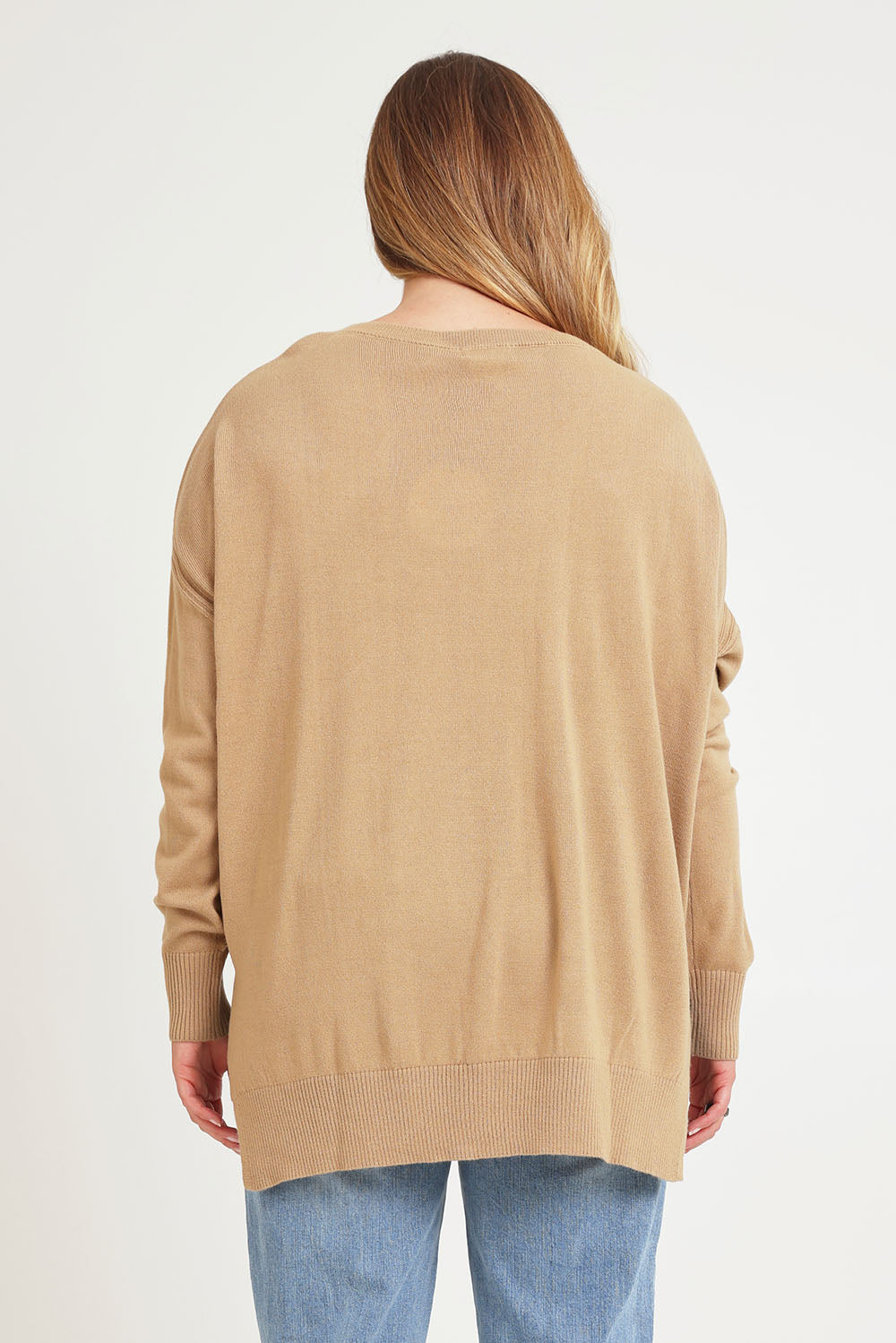 Model Chanel wearing size XL of The High Low V Neck Jumper in colour Fawn, from the back