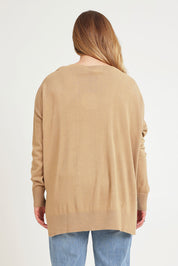 Model Chanel wearing size XL of The High Low V Neck Jumper in colour Fawn, from the back