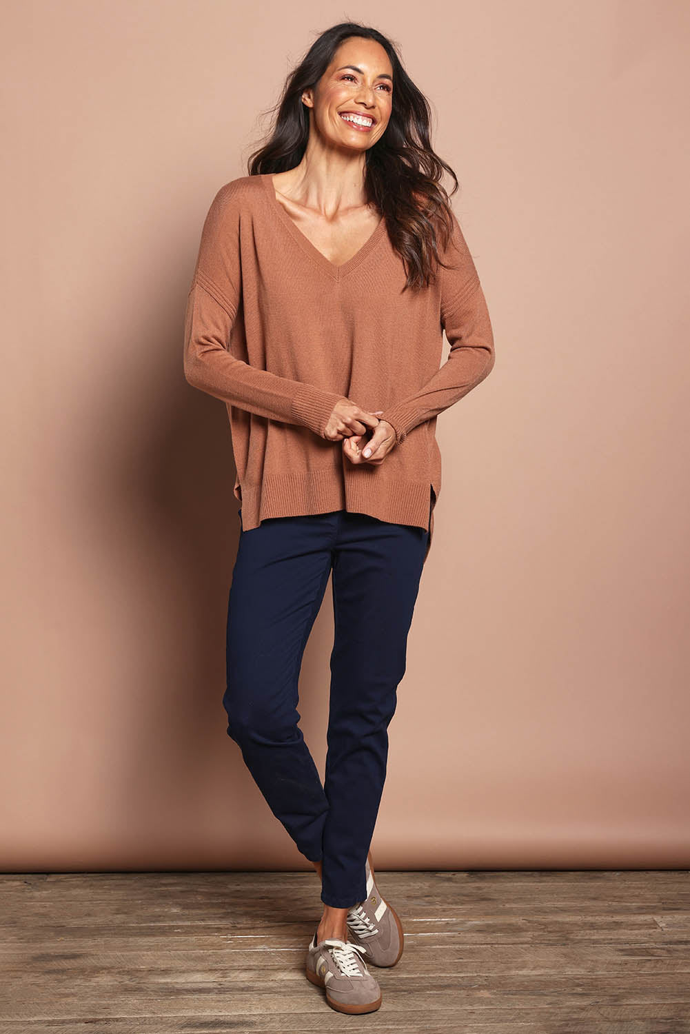 Model Amanda wearing size S of The High Low V Neck Jumper in colour Mushroom, from the front, showing the whole outfit