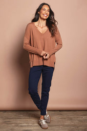 Model Amanda wearing size S of The High Low V Neck Jumper in colour Mushroom, from the front, showing the whole outfit