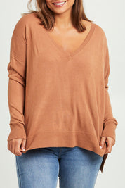 Model Monique wearing size L of The High Low V Neck Jumper in colour Mushroom, from the front, cropped image