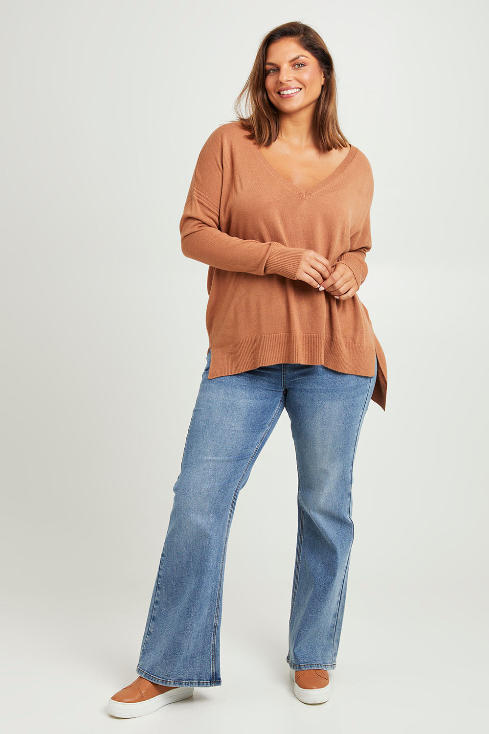 Model Monique wearing size L of The High Low V Neck Jumper in colour Mushroom, from the front, showing the whole outfit