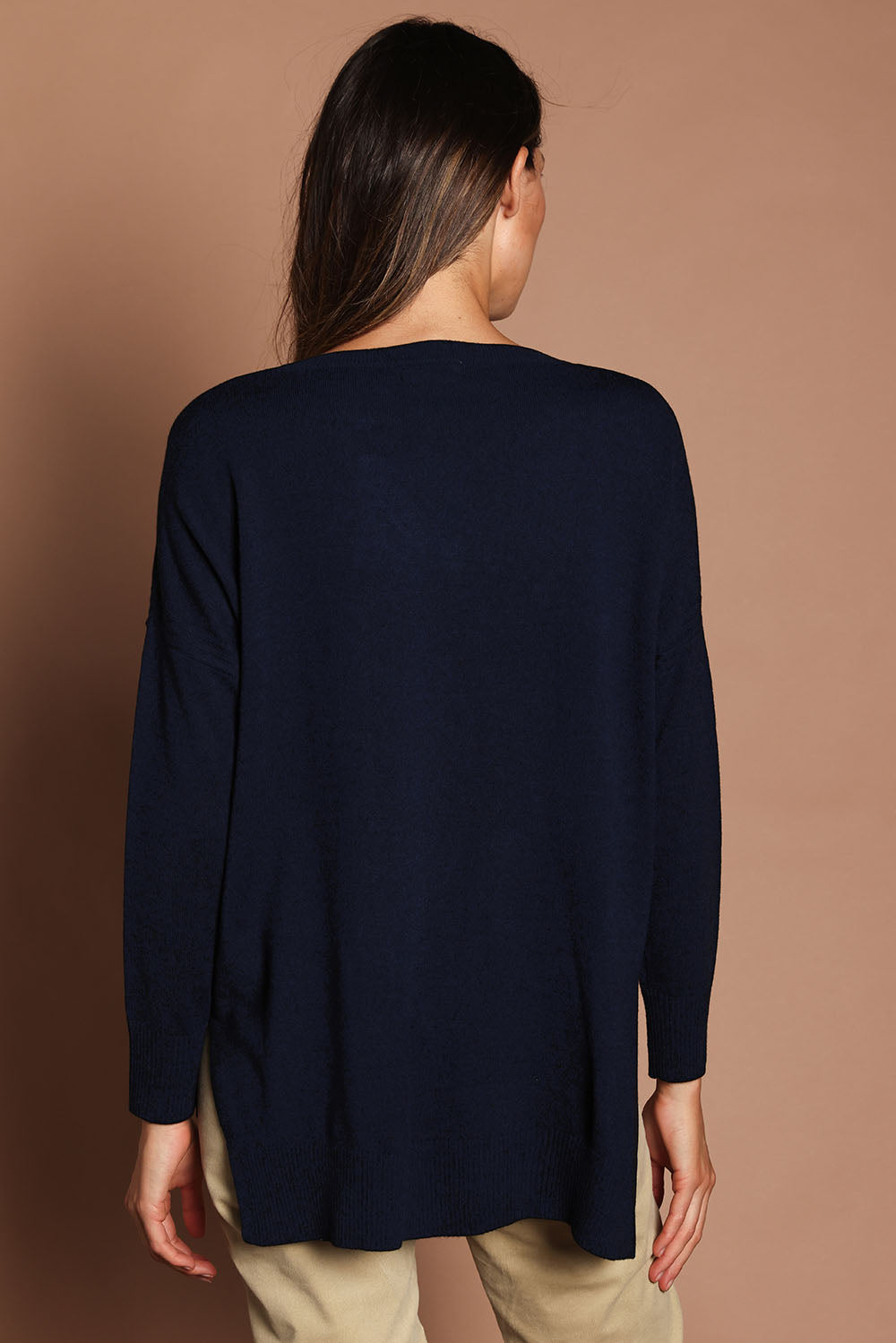 Model Madeline wearing size S of The High Low V Neck Jumper in colour Navy (Blue), from the back