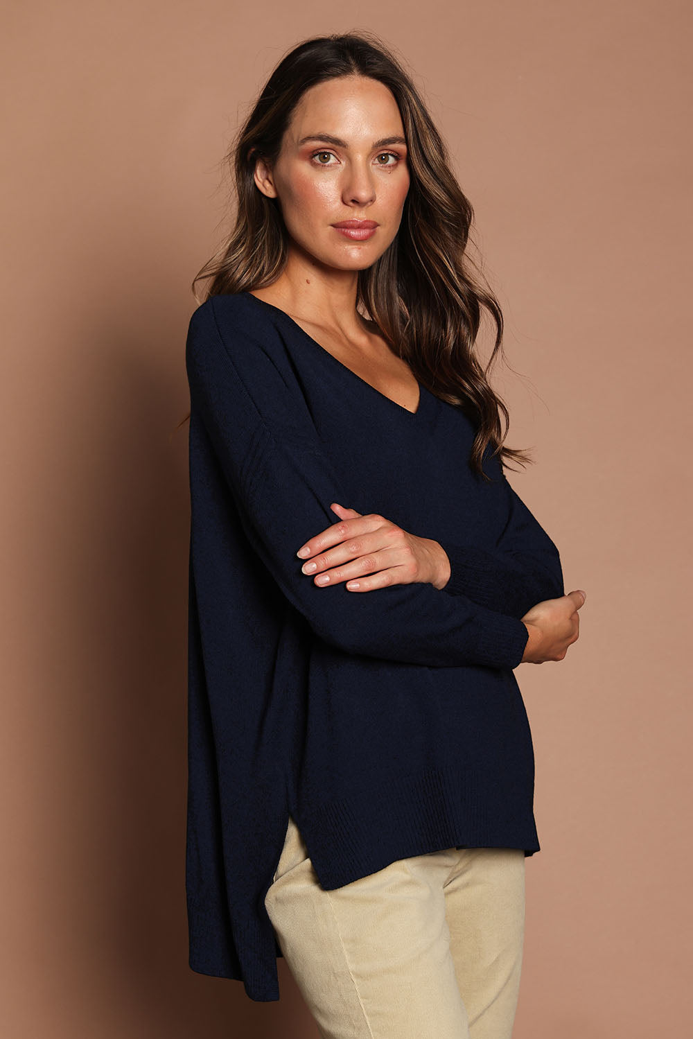Model Madeline wearing size S of The High Low V Neck Jumper in colour Navy (Blue), from the front, cropped image