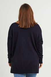 Model Monique wearing size L of The High Low V Neck Jumper in colour Navy (Blue), from the back