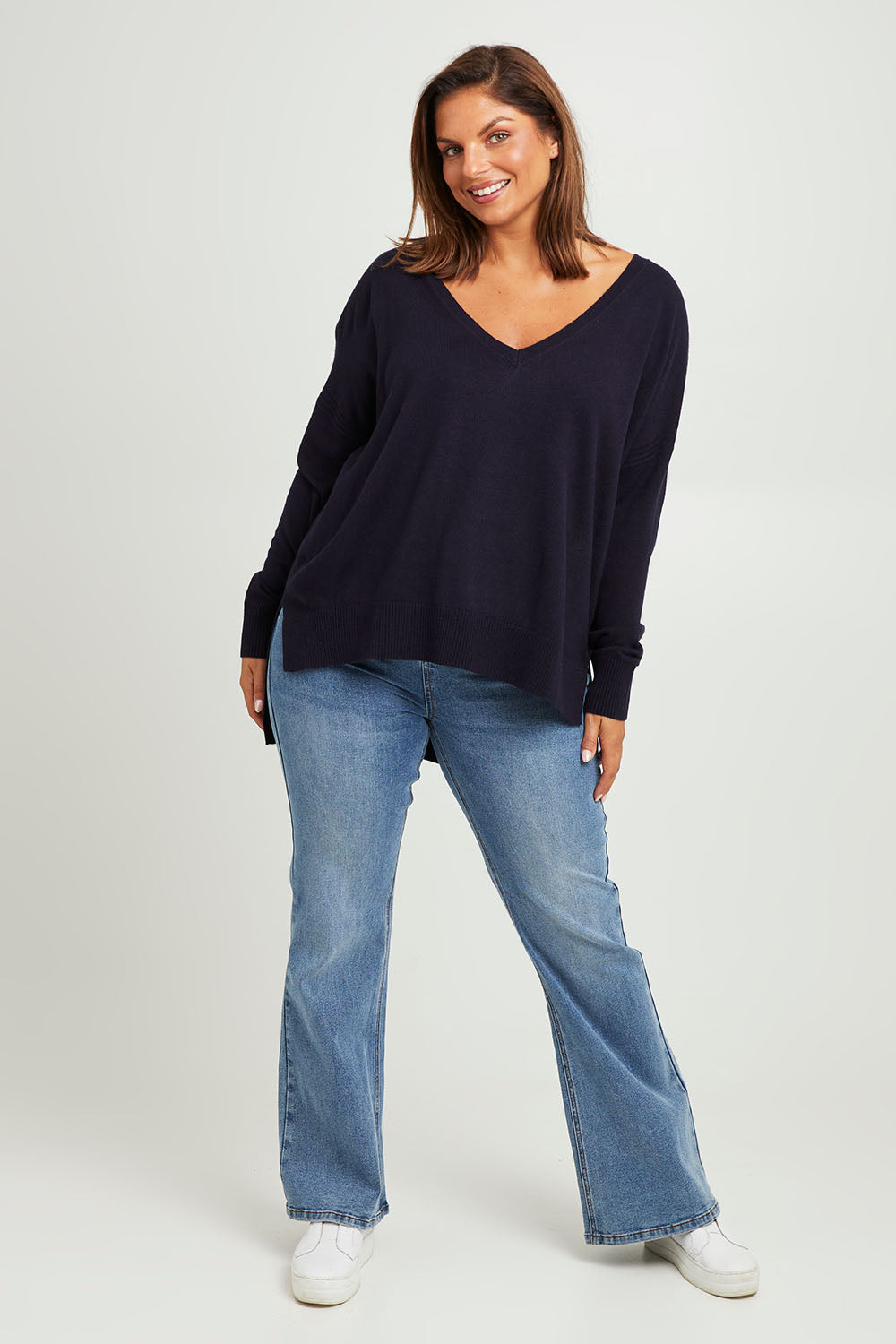 Model Monique wearing size L of The High Low V Neck Jumper in colour Navy (Blue), from the front, showing the whole outfit