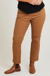 Model Laura wearing size 14 of The 7/8 Pull On Coloured Jean in colour Tobacco, from the front, cropped image