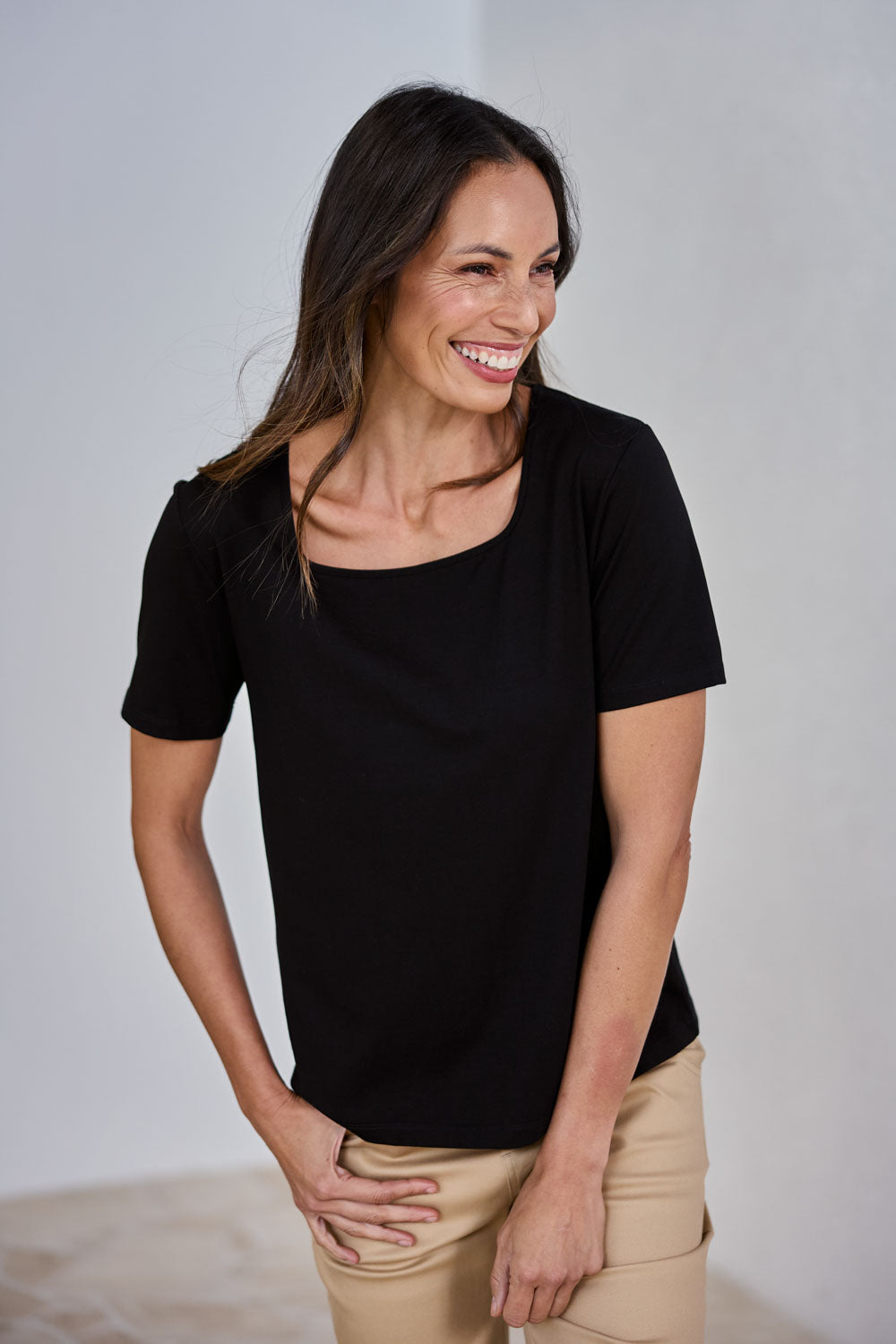 Model Amanda wearing size 10 of The Keepers Square Neck Tee in colour Black (Black), from the front, showing the whole outfit