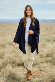 Model Amanda wearing The Every Season Poncho in colour Darknavy (Blue), from the front, showing the whole outfit