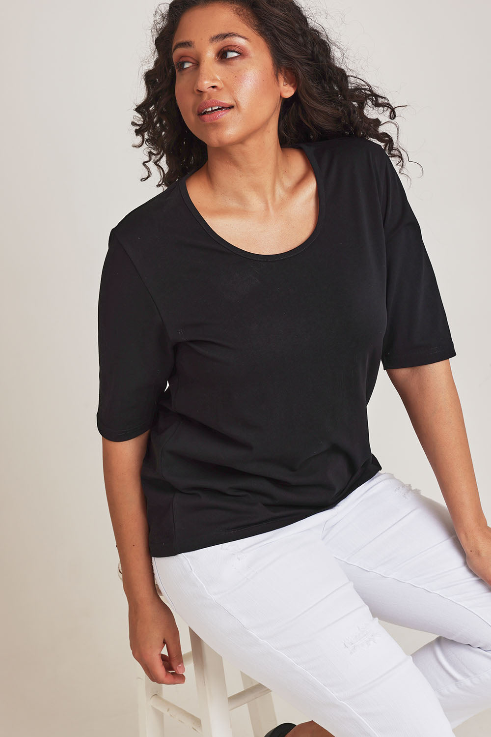 Model Terri-Leigh wearing size 14 of The Luxe Pima Cotton Tee in colour Black (Black), from the front, cropped image
