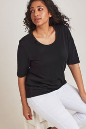 Model Terri-Leigh wearing size 14 of The Luxe Pima Cotton Tee in colour Black (Black), from the front, cropped image