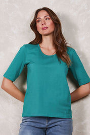 Model Madeline wearing size 10 of The Luxe Pima Cotton Tee in colour Grassgreen (Green), from the front, showing the whole outfit