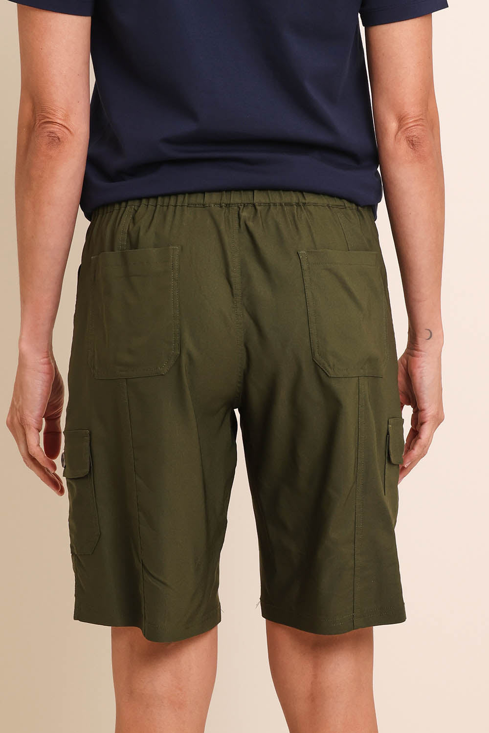 Model Amandam wearing size 10 of the The Utility Shorts  - Olive in colour Olive, from the back