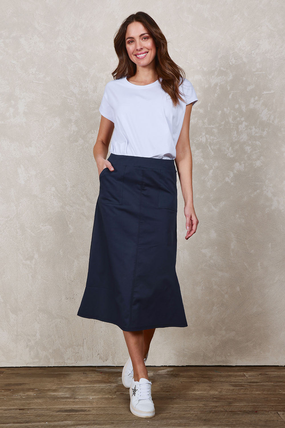 Model Madeline wearing size 10 of The Tencel Blend Pull On  Skirt in colour Navy (Blue), from the front, showing the whole outfit