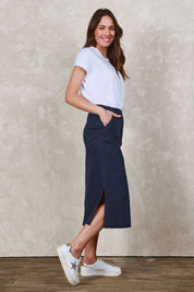 Model Madeline wearing size 10 of The Tencel Blend Pull On  Skirt in colour Navy (Blue), from the front, showing the whole outfit